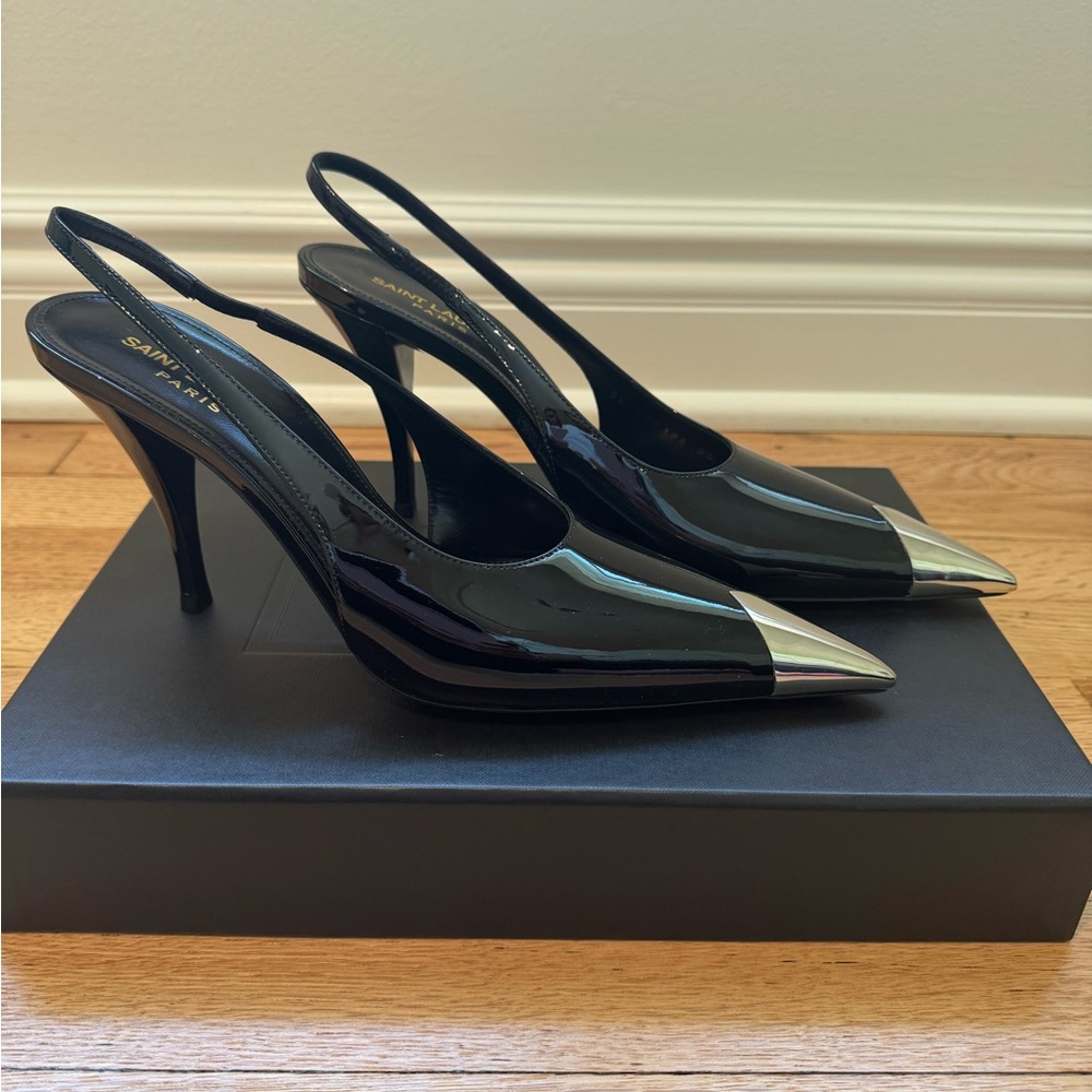 Saint Laurent Women’s patent leather silver cap toe sling back.